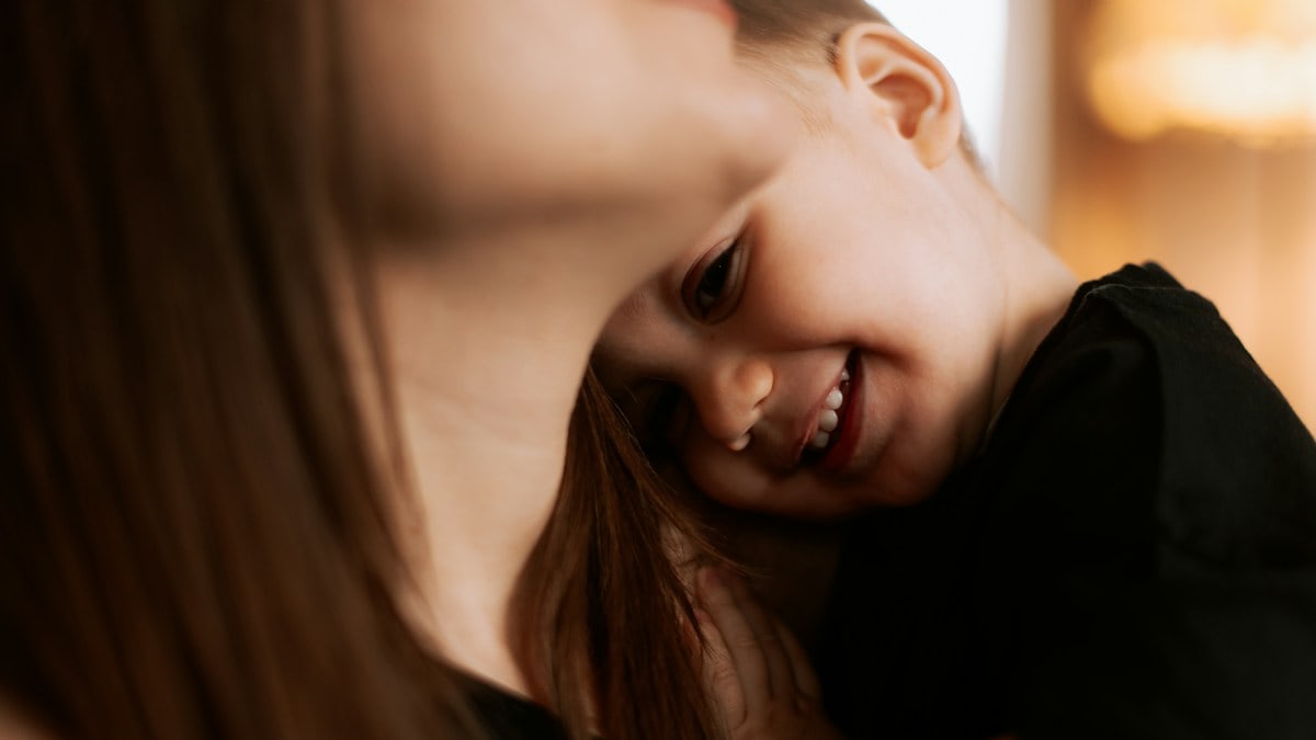 A woman holding a small child in her arms